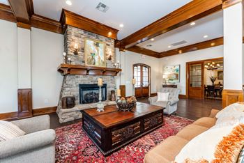 Resident clubhouse with large sofa, oversized chairs and fire place at Riverstone apartments for rent